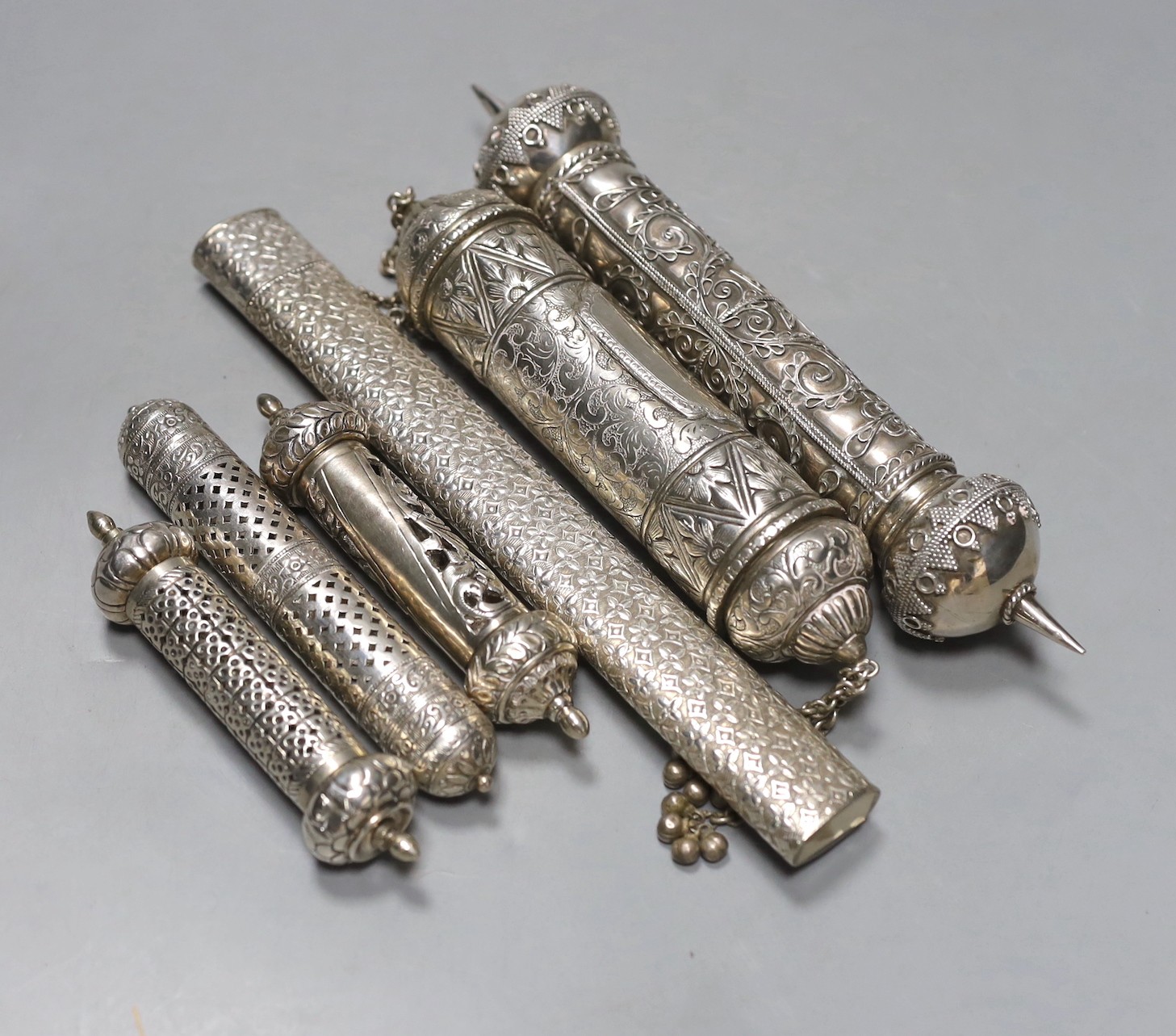Six assorted 20th century Indian white metal scroll cases, including three pierced, largest 24.5cm.